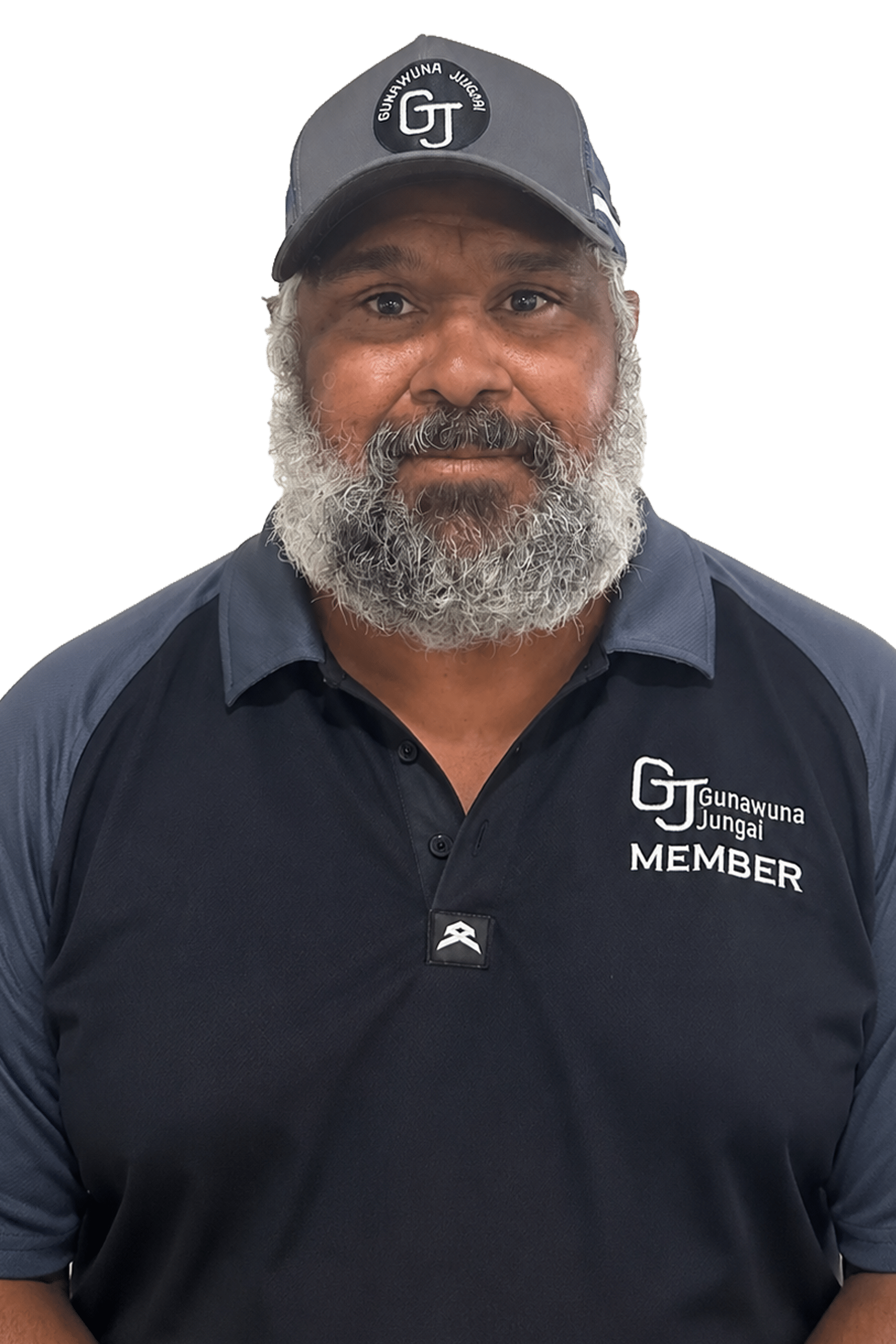 Portrait of a man with a gray beard wearing a dark polo shirt and cap with 'Gunawuna Jungai' badge on the chest and cap, neutral expression.